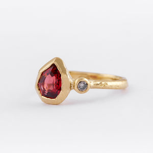 Geometric pear garnet in 9ct yellow gold with salt and pepper diamond.