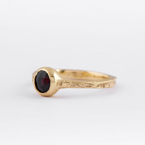 Solid 9ct yellow gold with dark red garnet and salt and pepper diamond